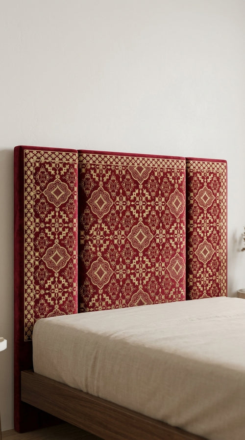 Bed with a decorative red headboard against a white wall