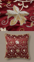 Decorative pillow with floral embroidery on a red background