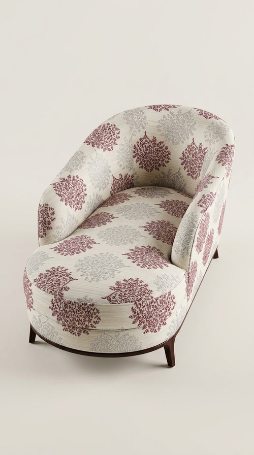 Luxury chaise longue lounge chair upholstered in a premium pink and white floral pattern fabric by Karigari Fabrics.